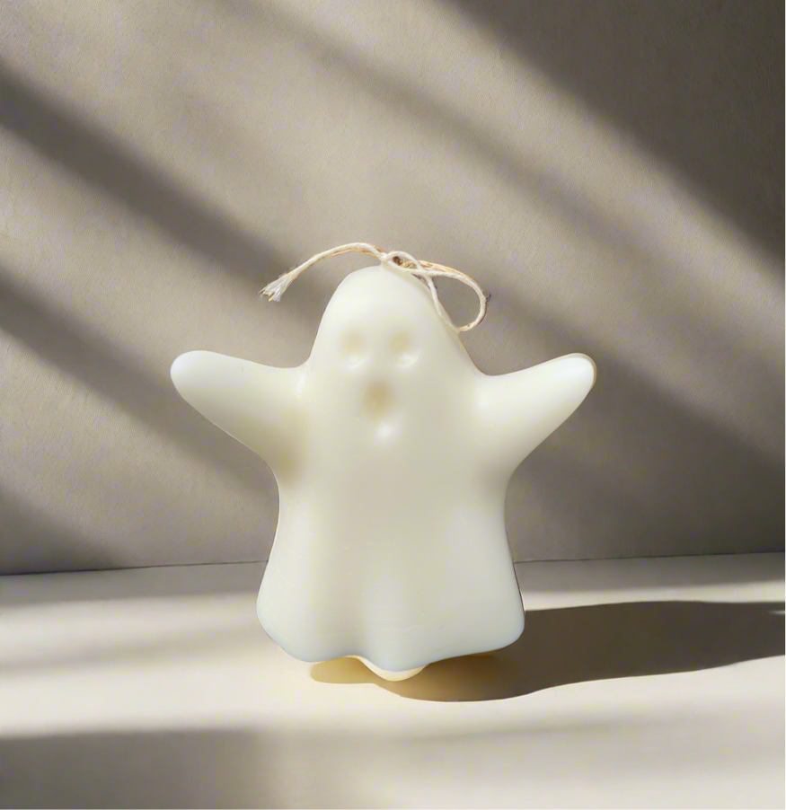 Candle in a ghost under a sheet shape 