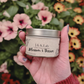 J&K Lab Travel Tin Candle -  Patchouli and Jasmine Scent - Held in Front of Flowers