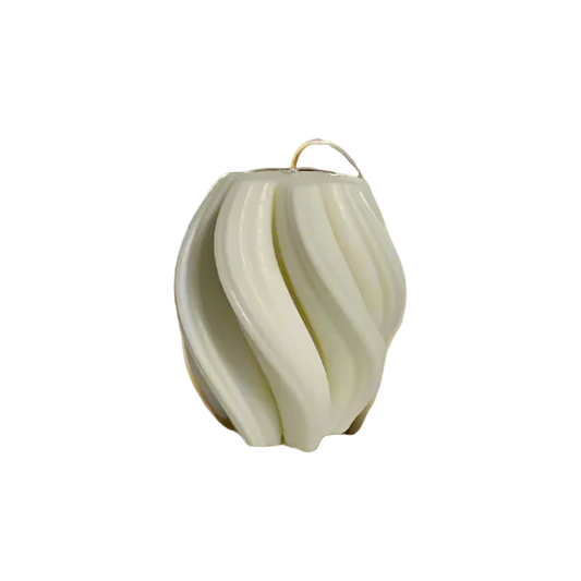 A white candle with a twisted geometric design